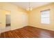 Bedroom featuring hardwood floors, a window, and a double door closet at 17910 Timber View St, Tampa, FL 33647