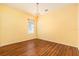 Bedroom with hardwood floors, a modern chandelier, and a sunlit window at 17910 Timber View St, Tampa, FL 33647