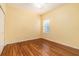 This bedroom includes hardwood floors and a large window for natural light at 17910 Timber View St, Tampa, FL 33647