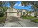 Well-maintained single-story home with a brick-paved driveway, surrounded by mature trees at 17910 Timber View St, Tampa, FL 33647