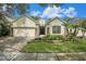 Charming single-story home featuring a well-manicured lawn and a brick-paved driveway at 17910 Timber View St, Tampa, FL 33647