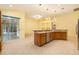 Spacious kitchen features a center island, stainless appliances, and open access to the screened in lanai at 17910 Timber View St, Tampa, FL 33647