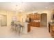 Large, open kitchen with stainless appliances, wooden cabinets, and breakfast bar seating at 17910 Timber View St, Tampa, FL 33647