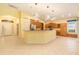 Open concept living space featuring modern lighting and a seamless flow to the kitchen at 17910 Timber View St, Tampa, FL 33647