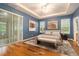 Spacious main bedroom with tray ceiling, wood floors, and large sliding glass door to a patio at 17910 Timber View St, Tampa, FL 33647