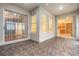 Covered patio with textured tile flooring, sliding glass doors, and direct interior home access at 17910 Timber View St, Tampa, FL 33647
