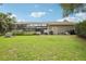 Green backyard featuring a screened-in lanai, providing a bug-free outdoor living space and outdoor amenities at 1803 143Rd E Ct, Bradenton, FL 34212