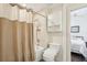 Clean bathroom with a shower, toilet, linen storage and a view into the nearby bedroom at 1803 143Rd E Ct, Bradenton, FL 34212