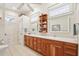 Bright bathroom with double vanity, wood cabinets, and ample natural light at 1803 143Rd E Ct, Bradenton, FL 34212
