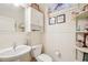 Cozy half bathroom featuring decorative elements and a pedestal sink at 1803 143Rd E Ct, Bradenton, FL 34212