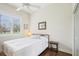 Bright bedroom featuring a ceiling fan, hardwood floors, and large windows with lovely outdoor views at 1803 143Rd E Ct, Bradenton, FL 34212