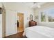 A bright bedroom with hardwood floors, a ceiling fan, and access to an ensuite bathroom at 1803 143Rd E Ct, Bradenton, FL 34212