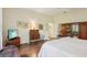 Comfortable bedroom with hardwood floors, white walls, and wood accents at 1803 143Rd E Ct, Bradenton, FL 34212