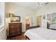 Bedroom featuring wood floors, access to a bathroom and a closet at 1803 143Rd E Ct, Bradenton, FL 34212