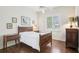 Bedroom boasts hardwood floors, a ceiling fan, and a bright window with plantation shutters at 1803 143Rd E Ct, Bradenton, FL 34212