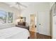 Bedroom featuring wood floors, a ceiling fan and a connecting bathroom at 1803 143Rd E Ct, Bradenton, FL 34212
