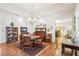 Dining room featuring hardwood floors, chandelier, and access to the kitchen at 1803 143Rd E Ct, Bradenton, FL 34212