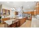 Spacious kitchen featuring a large island, stainless steel appliances, and custom wood cabinetry at 1803 143Rd E Ct, Bradenton, FL 34212