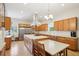Well-appointed kitchen boasting a large island, stainless steel refrigerator, and ample counter space at 1803 143Rd E Ct, Bradenton, FL 34212