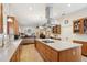 Elegant kitchen showcasing an open design, a large island, and seamless flow into the adjacent living space at 1803 143Rd E Ct, Bradenton, FL 34212