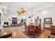 Open concept living room featuring hardwood floors, decorative ceiling fan, and unique furniture at 1803 143Rd E Ct, Bradenton, FL 34212
