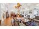 Bright and open living room with wooden floors, decorative ceiling fan, and access to dining area at 1803 143Rd E Ct, Bradenton, FL 34212