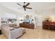 Cozy living room with a large sectional, unique decor, and a ceiling fan for added comfort at 1803 143Rd E Ct, Bradenton, FL 34212