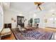 Living room featuring hardwood floors, unique furniture, and decorative ceiling fan at 1803 143Rd E Ct, Bradenton, FL 34212