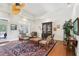 Living room featuring hardwood floors, decorative ceiling fan, and unique furniture at 1803 143Rd E Ct, Bradenton, FL 34212