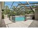 Screened-in pool area with a safety fence and shaded patio at 1803 143Rd E Ct, Bradenton, FL 34212