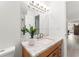 Bathroom with granite countertop vanity, a potted plant, and a large well-lit mirror at 1909 Dover Ct, Oldsmar, FL 34677