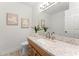 Bright bathroom featuring a granite countertop vanity and decorative floral art at 1909 Dover Ct, Oldsmar, FL 34677