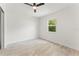 Well-lit bedroom with wood-look floors, ceiling fan, and window view at 1909 Dover Ct, Oldsmar, FL 34677