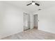 Neutral bedroom featuring wood-look floors, ceiling fan, and mirrored closet doors at 1909 Dover Ct, Oldsmar, FL 34677