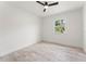 Bright bedroom with ceiling fan and light wood-look flooring and window with view to outside at 1909 Dover Ct, Oldsmar, FL 34677