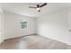 Bright bedroom featuring modern ceiling fan and new flooring at 1909 Dover Ct, Oldsmar, FL 34677
