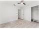 Light-filled bedroom with wood-look floors, ceiling fan, and walk-in closet at 1909 Dover Ct, Oldsmar, FL 34677