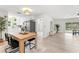 Bright dining area with hardwood floors, seamlessly connected to the kitchen and living room, offering a view of the outdoor pool at 1909 Dover Ct, Oldsmar, FL 34677