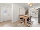Inviting dining area featuring a light wood table, elegant chairs, neutral decor, and hardwood floors, adjacent to the kitchen at 1909 Dover Ct, Oldsmar, FL 34677