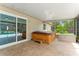 Outdoor screened in patio with hot tub, tiled flooring, and sliding glass doors at 1909 Dover Ct, Oldsmar, FL 34677