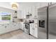 Bright, renovated kitchen with stainless steel appliances, white cabinets, and open layout at 1909 Dover Ct, Oldsmar, FL 34677