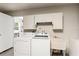 Laundry room featuring a washer, dryer, utility sink and cabinets for storage at 1909 Dover Ct, Oldsmar, FL 34677