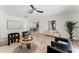 Open-concept living room with contemporary furnishings, neutral color palette, and hardwood floors, seamlessly connected to the dining area at 1909 Dover Ct, Oldsmar, FL 34677