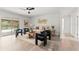 Living room with modern furnishings, hardwood floors, and view to a private pool creating an indoor-outdoor living experience at 1909 Dover Ct, Oldsmar, FL 34677