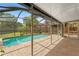 A screened-in pool and patio offer a private oasis in this backyard at 1909 Dover Ct, Oldsmar, FL 34677