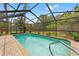 Beautiful in-ground pool in an enclosed backyard with lush landscaping and brick-paved patio at 1909 Dover Ct, Oldsmar, FL 34677