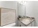 Bright powder room with granite counters, brushed nickel fixtures, and stylish mountain-themed artwork at 1909 Dover Ct, Oldsmar, FL 34677