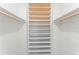 Spacious walk-in closet with built-in shelving and wooden rods for ample storage at 1909 Dover Ct, Oldsmar, FL 34677