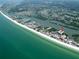 Aerial view of the condo complex on the beach, showcasing waterfront location, and the surrounding community at 19531 Gulf Blvd # 306, Indian Shores, FL 33785
