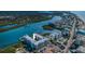 Aerial view of the waterfront community featuring views of the waterfront building, docks, boat slips, and parking at 19531 Gulf Blvd # 306, Indian Shores, FL 33785